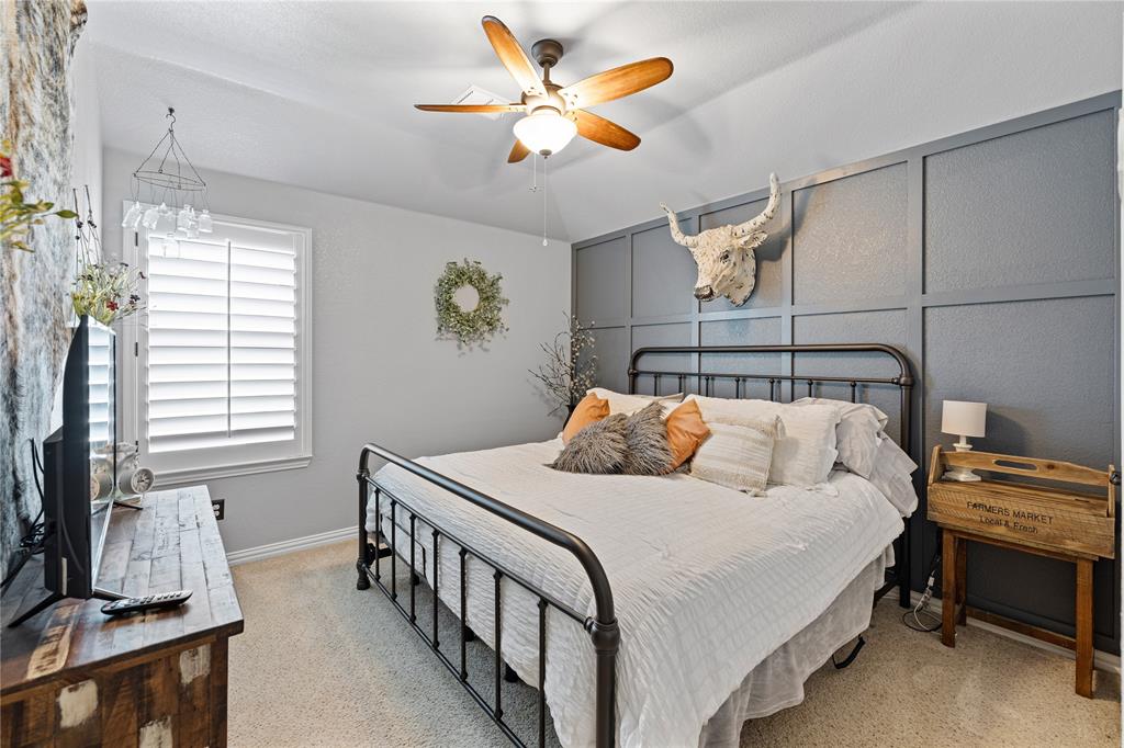 Carpeted bedroom with ceiling fan