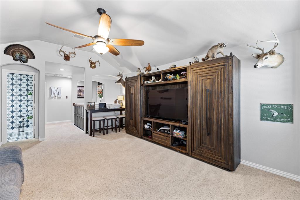 Living room with light carpet, ceiling fan, and lofted ceiling