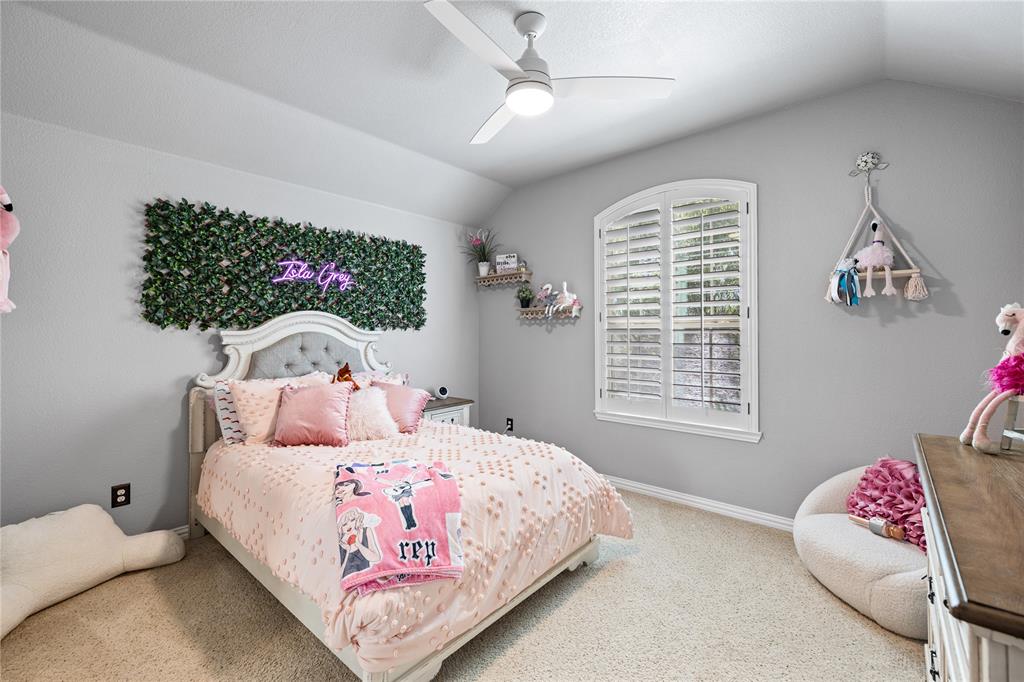 Bedroom featuring light carpet, ceiling fan, and lofted ceiling
