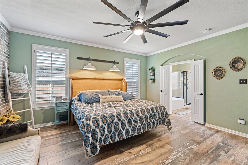 Bedroom featuring ceiling fan, crown molding, and hardwood / wood-style flooring