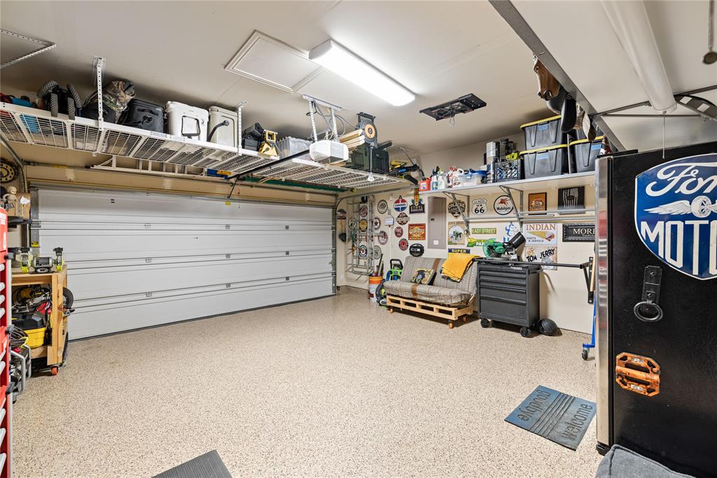 Garage with a workshop area and a garage door opener
