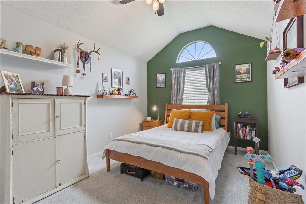 Interior room featuring a vaulted ceiling and an arched transom window