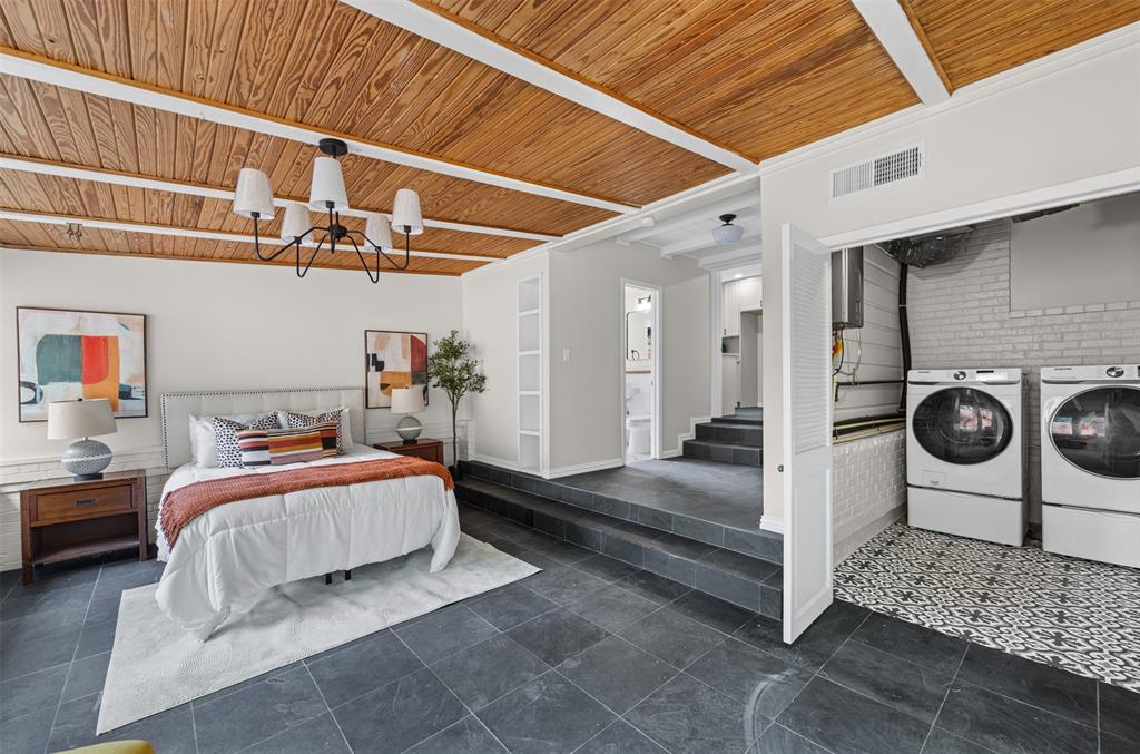 Bedroom with laundry. This room has sliding doors leading to the back patio