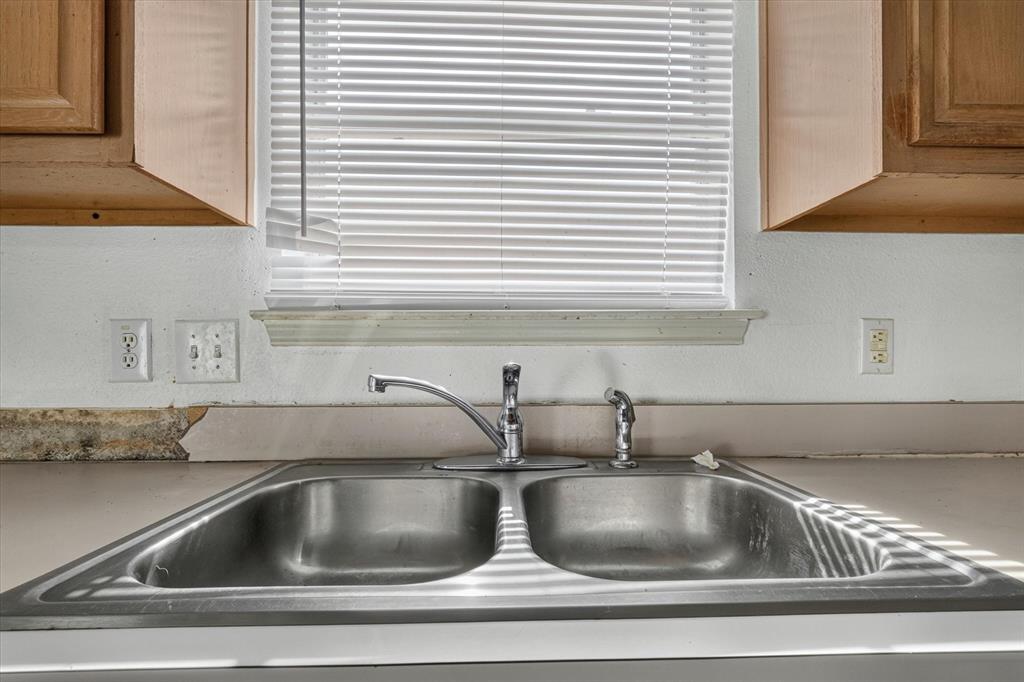 Stainless steel double basin sink with a chrome faucet