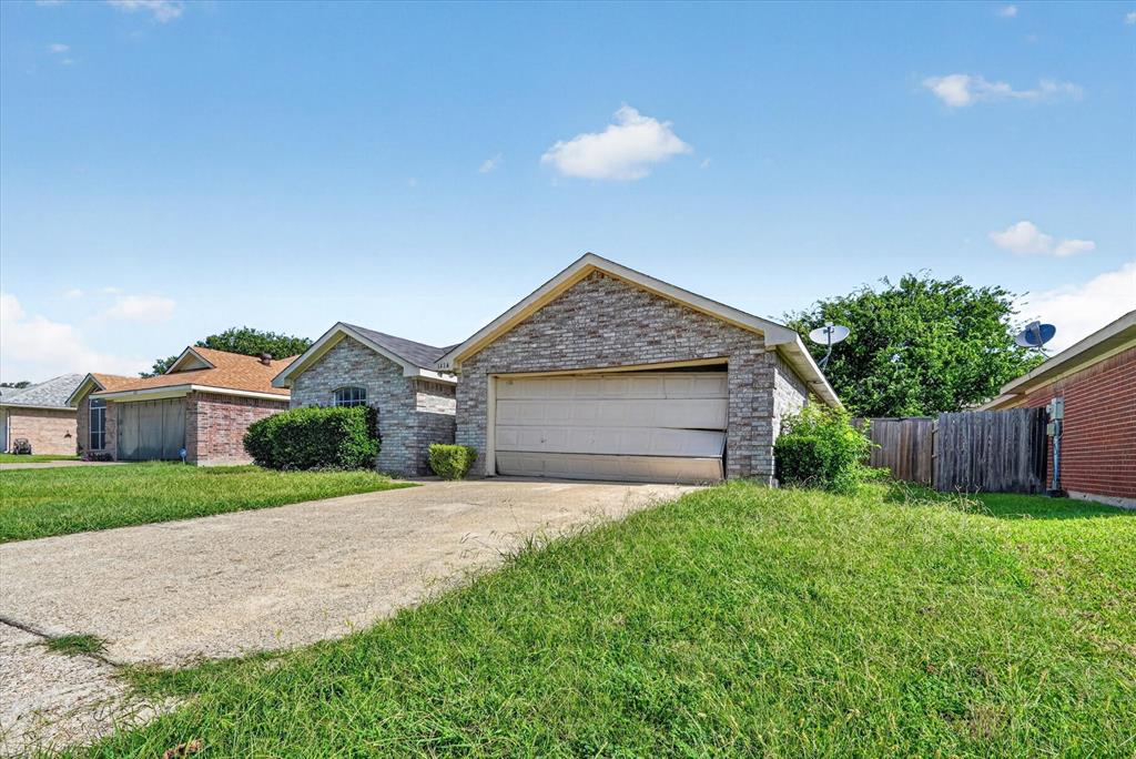 Stone veneer facade with an integrated single-car garage and concrete driveway