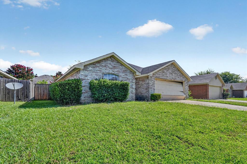 Stone veneer facade with a single-car garage and arched window