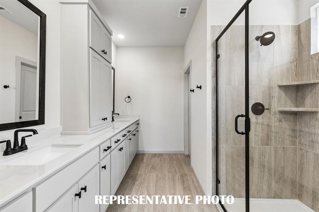 You will love the spacious walk in shower in this beautiful owner's bath.  REPRESENTATIVE PHOTO