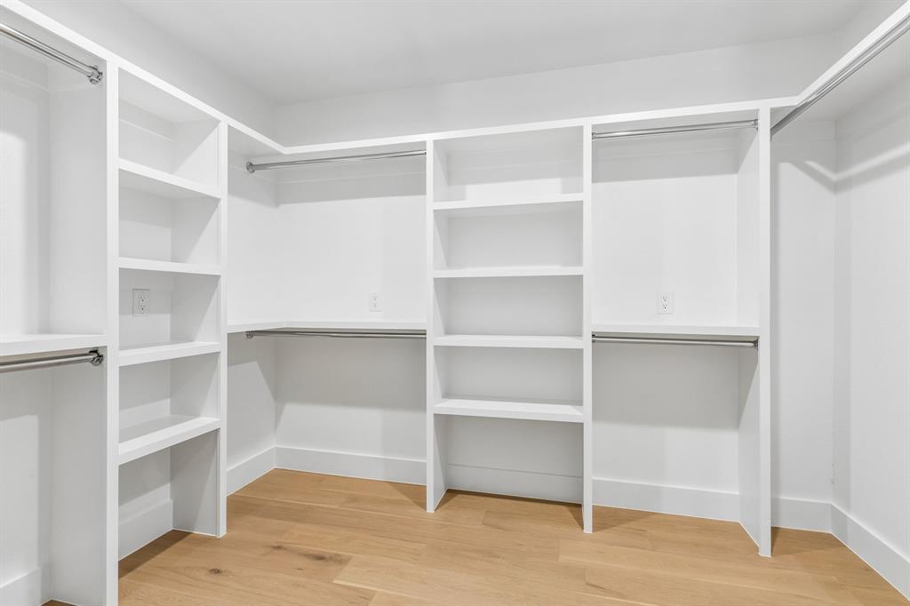 One of two closets in the primary suite,complete with shelving.