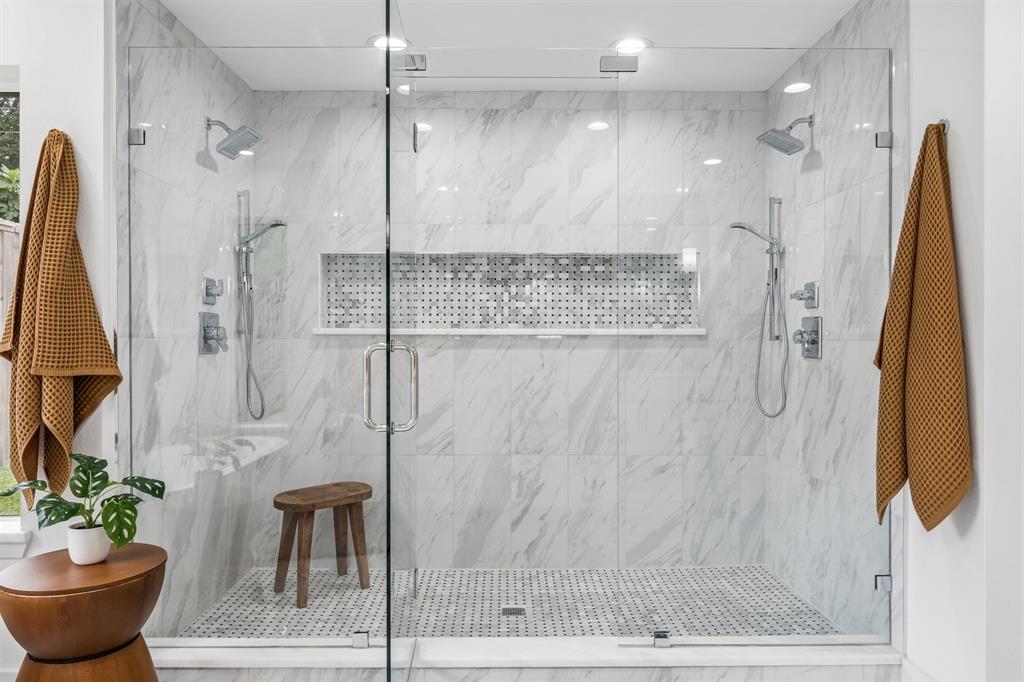 Oversized frameless shower in primary with bench and niche