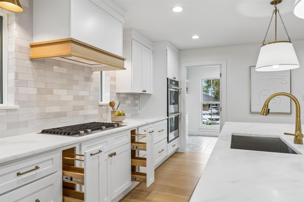 All the extras..spice drawers frame the cabinetry beneath the gas range