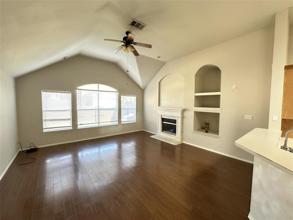 Vaulted ceilings and wood-finish flooring enhance this living area