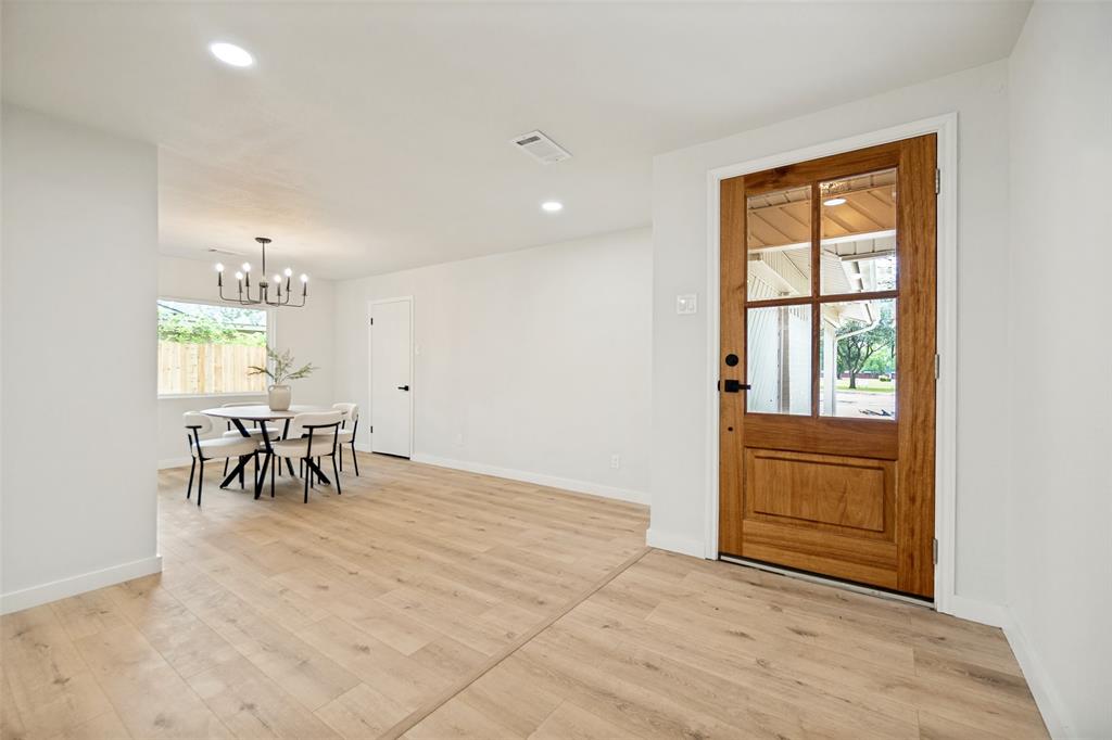 Entryway featuring a natural wood-finish door with multi-pane glass