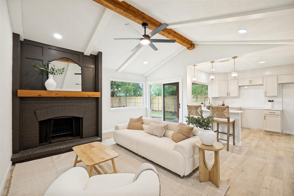Vaulted ceiling with exposed wood beam and ceiling fan