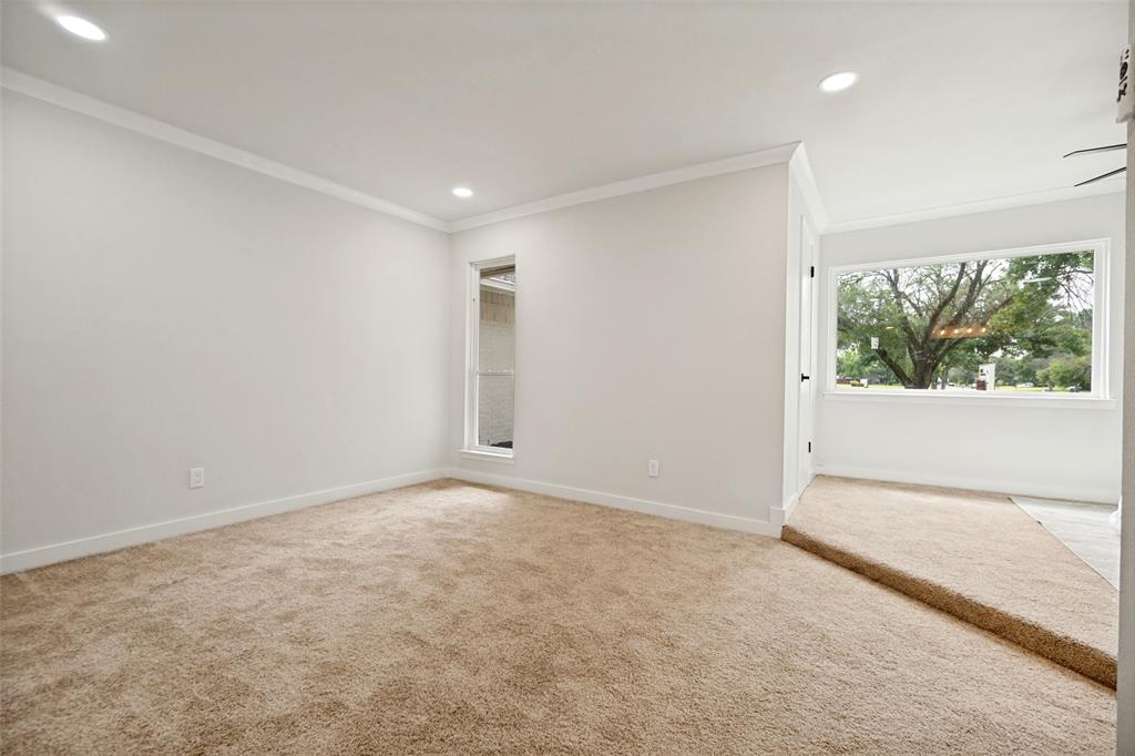 Carpeted interior space featuring recessed lighting and crown molding