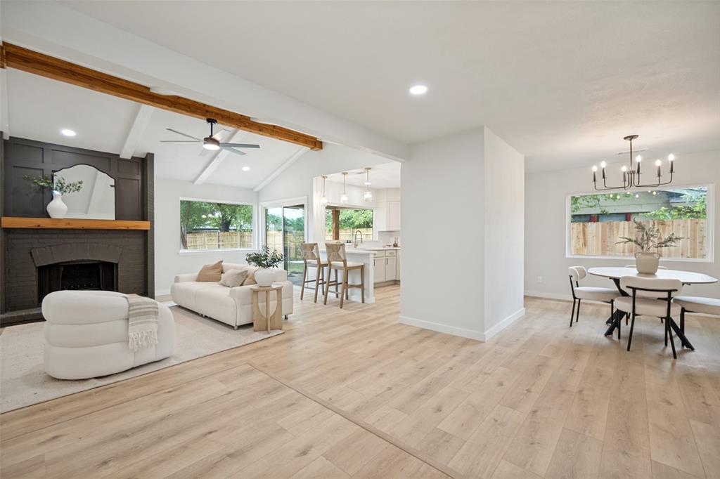 Vaulted ceilings with exposed wood beams highlight this expansive living area