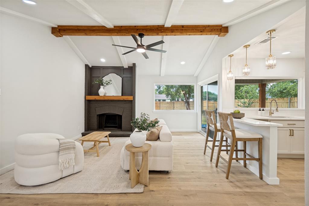 Vaulted ceiling with exposed wood beams and ceiling fan
