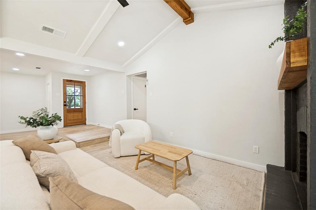 Vaulted white ceiling with exposed wood beams