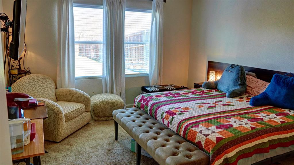 Carpeted bedroom with a built-in headboard and integrated side tables