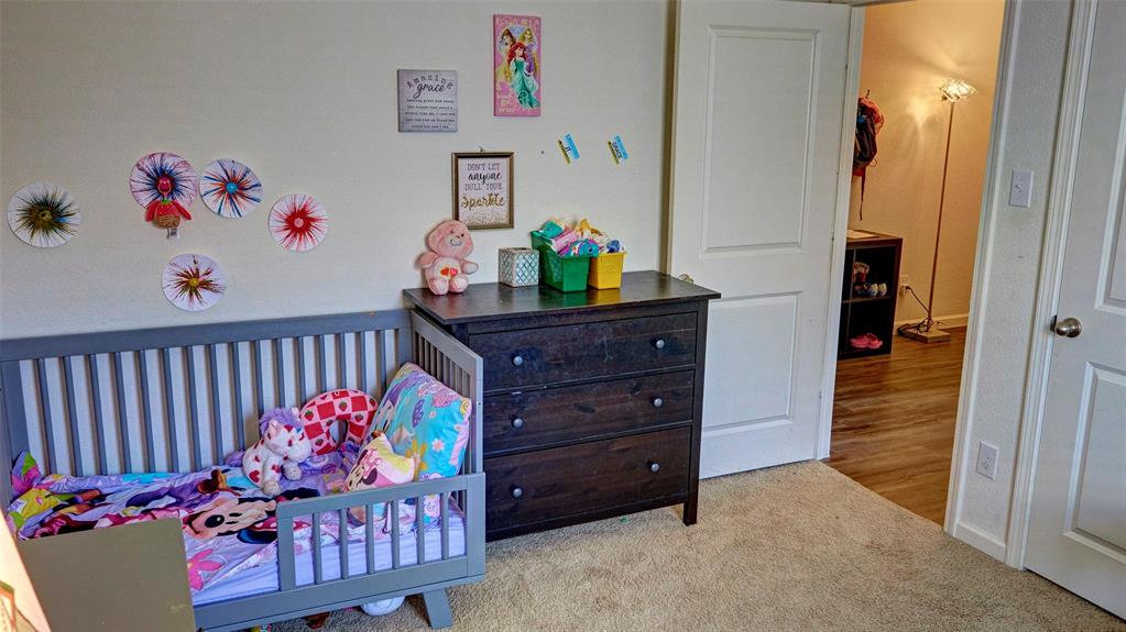Carpeted flooring, white interior doors, and a neutral wall color