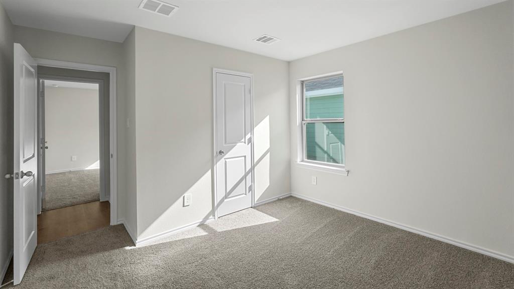 Carpeted room with white painted walls, a single window, and white trim