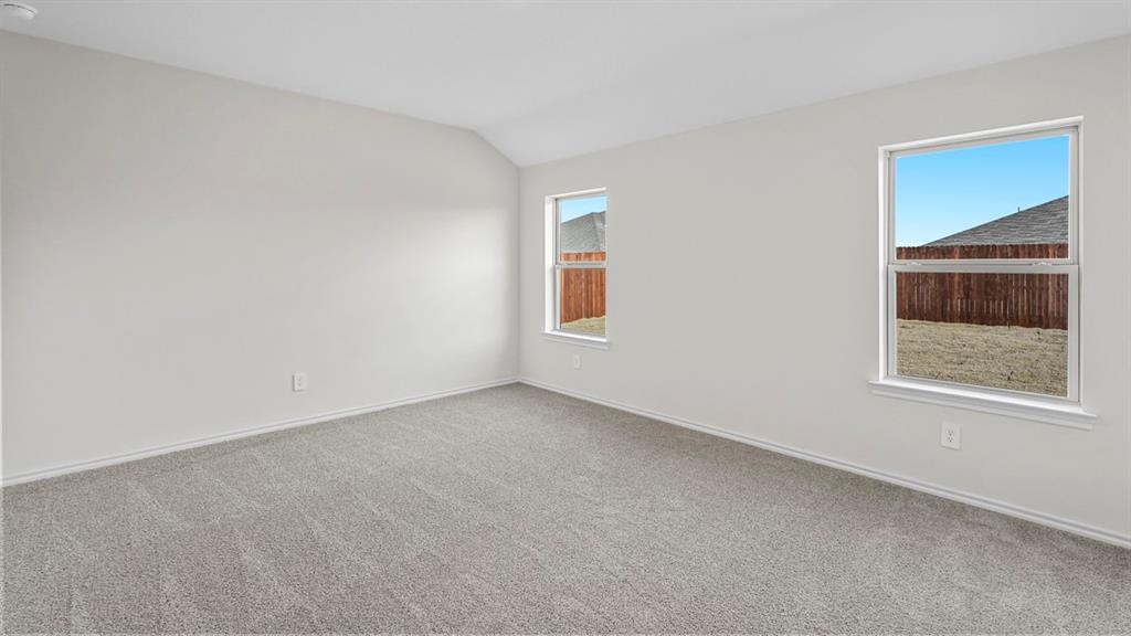 Spacious room featuring neutral carpeting and light-toned walls