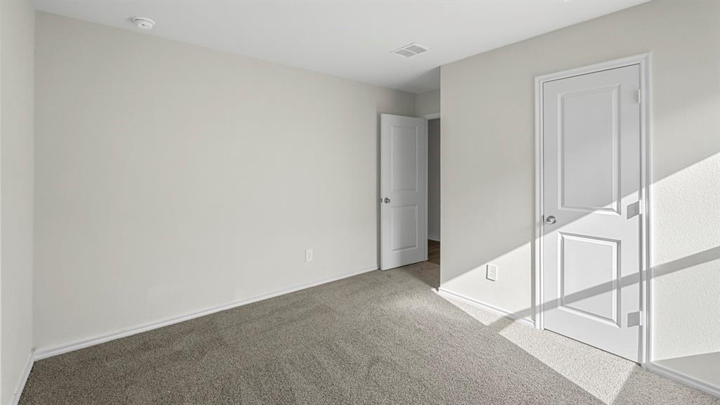 Neutral-toned walls and grey carpet flooring define this interior space