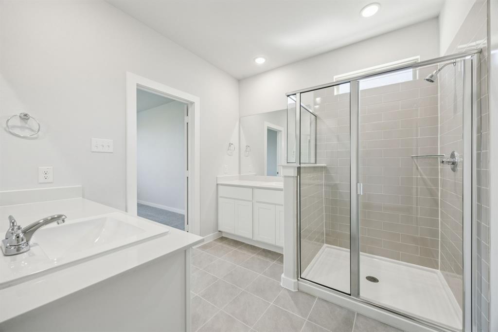 Primary Bathroom in the Masters home plan by Trophy Signature Homes – REPRESENTATIVE PHOTO
