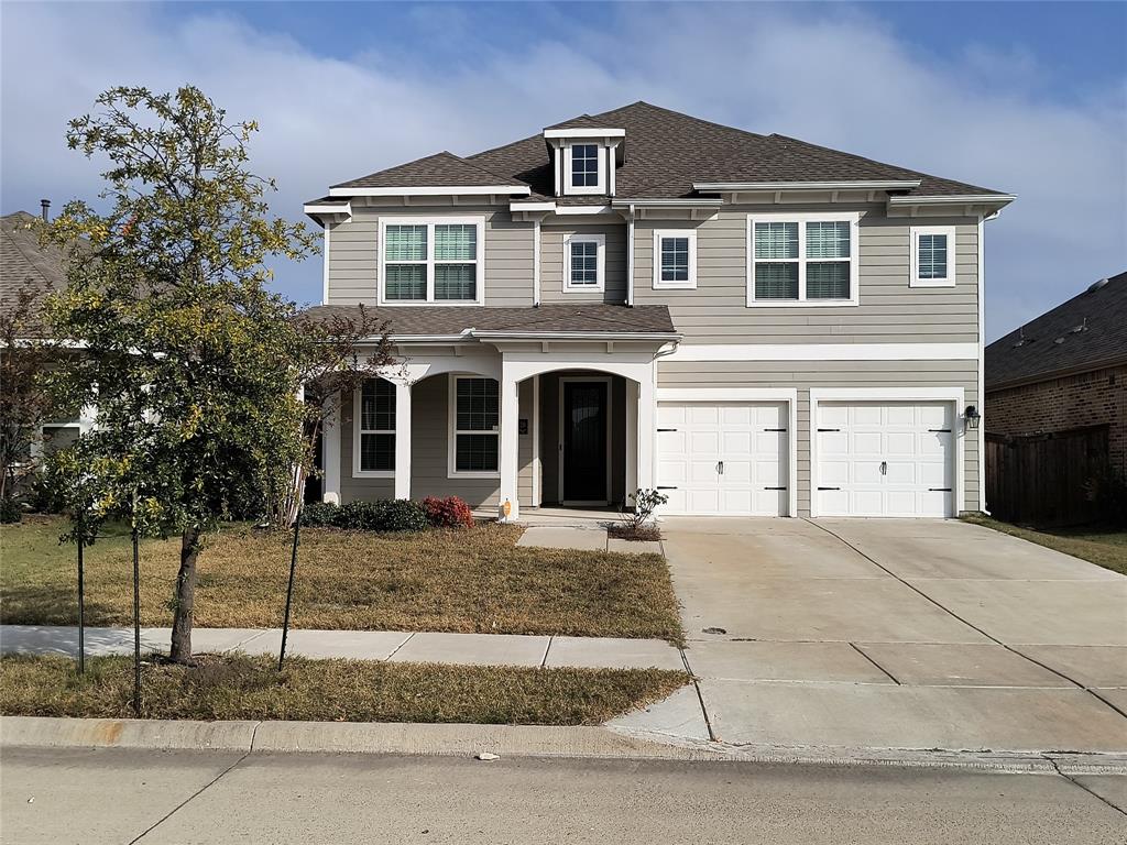 Two-story residence featuring light gray siding, white trim, and a prominent front entrance with a covered porch Two-story residence featuring light gray siding, white trim, and a prominent front entrance with a covered porch