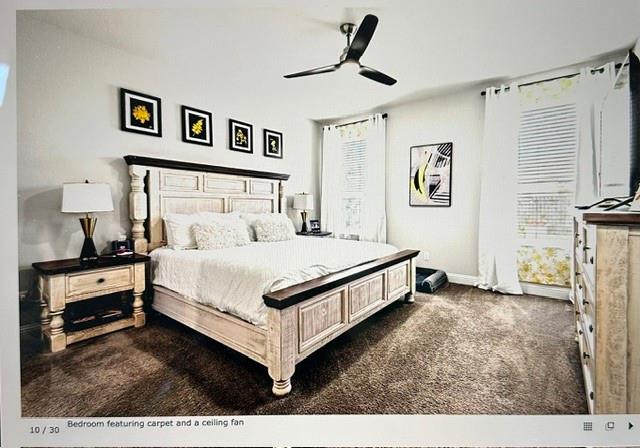 Carpeted room featuring a ceiling fan, window blinds, and white curtains