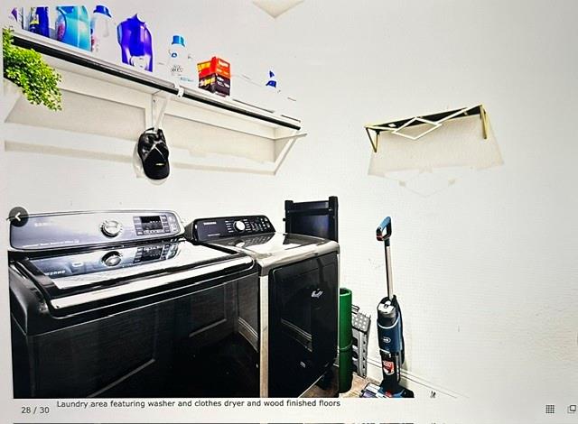 Laundry area featuring a built-in shelf, white walls, and dark wood-finish flooring