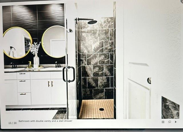 Double vanity with undermount sinks and contemporary gold-framed circular mirrors