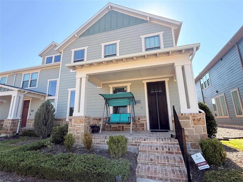 Two-story residence featuring light gray siding with white trim accents and a contrasting dark front door Two-story residence featuring light gray siding with white trim accents and a contrasting dark front door