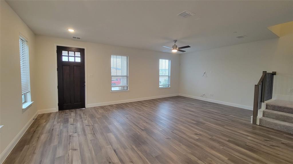 Open-concept living space featuring wood-finish flooring, recessed lighting, and a modern ceiling fan