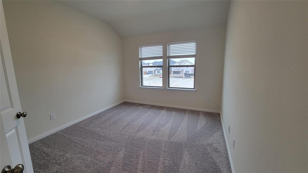 Neutral-toned walls and plush gray carpeting characterize this room