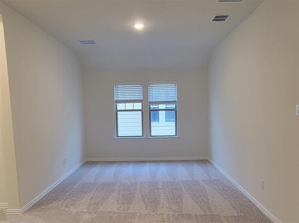 Carpeted room featuring two windows with blinds, recessed lighting, and white baseboards