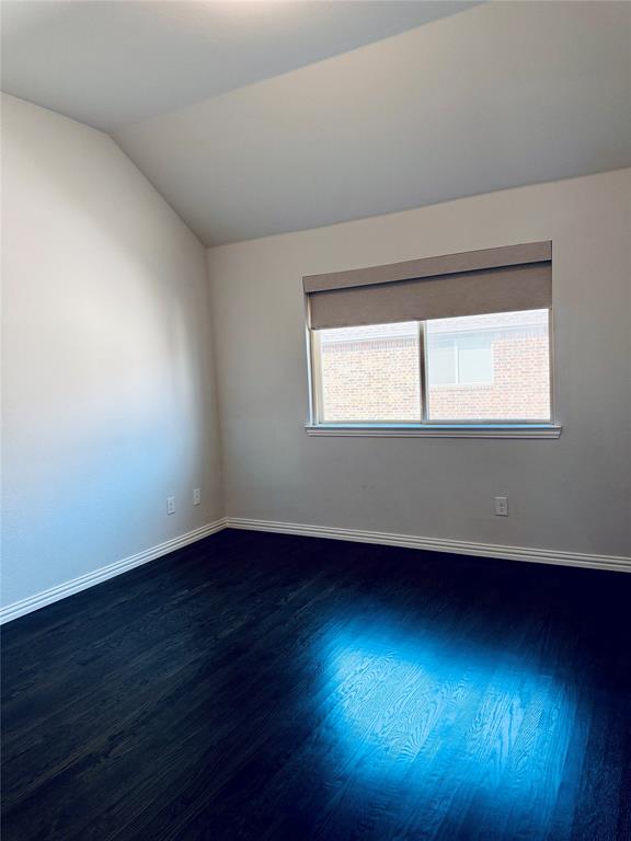 3rd bedroom featuring dark wood-finish flooring and light-toned walls