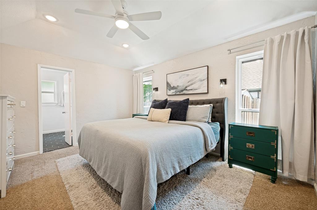 Bedroom featuring a textured accent wall, recessed lighting, and a ceiling fan