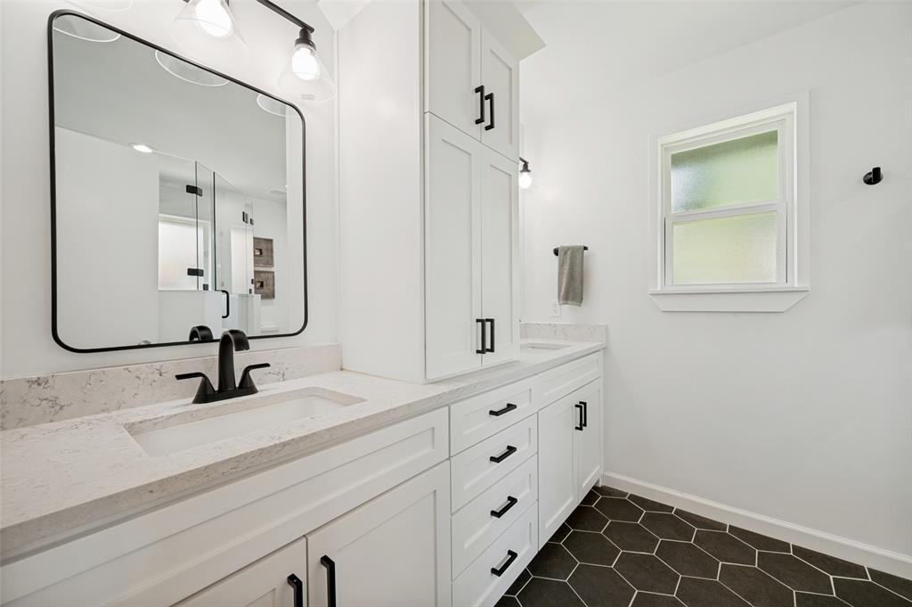 Dual vanity with light-toned countertops and integrated sinks