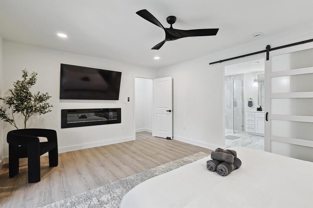 Spacious room with wood-finish flooring and recessed lighting
