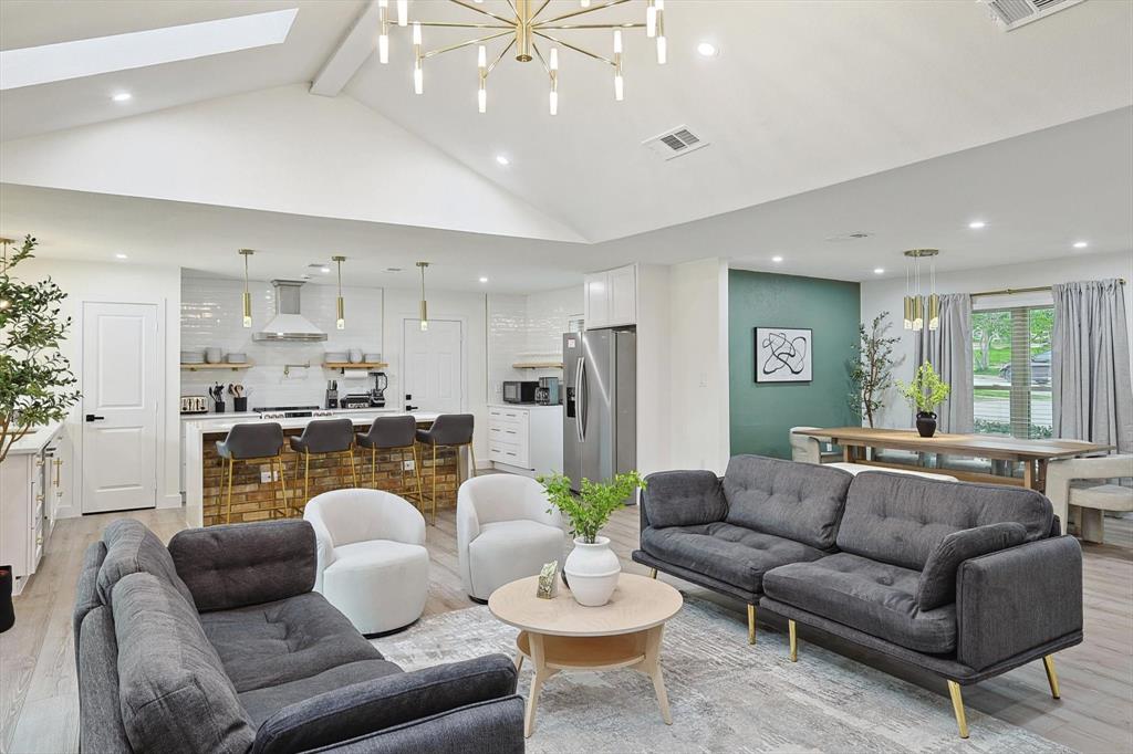 Vaulted ceiling with an overhead skylight and contemporary chandelier Vaulted ceiling with an overhead skylight and contemporary chandelier