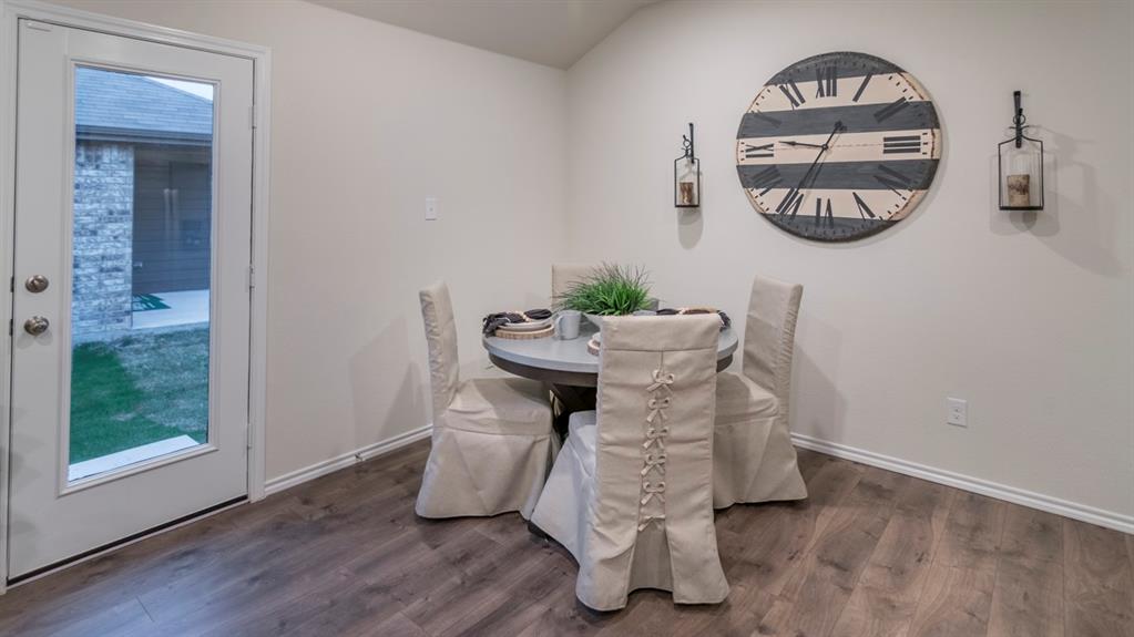 Hardwood-finish flooring complementing light wall tones and white baseboards