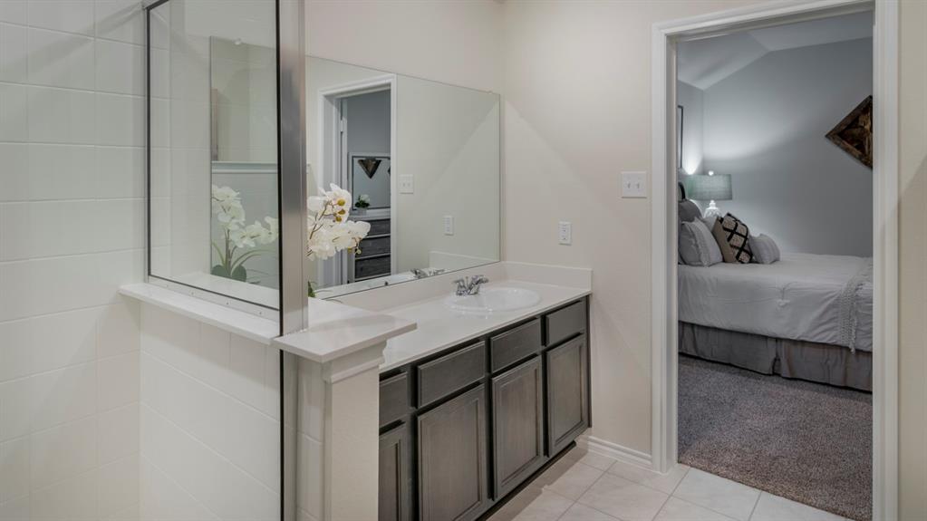 Bathroom vanity with a white countertop and undermount sink, complemented by gray cabinetry