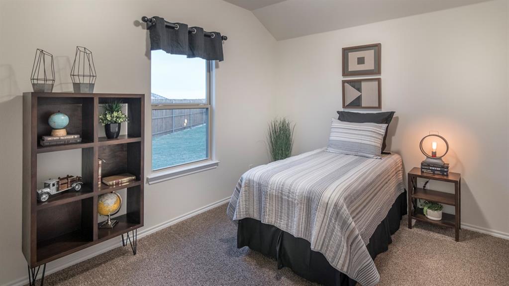 Neutral-toned room featuring a single window with a valance, soft carpet flooring, and light-colored walls