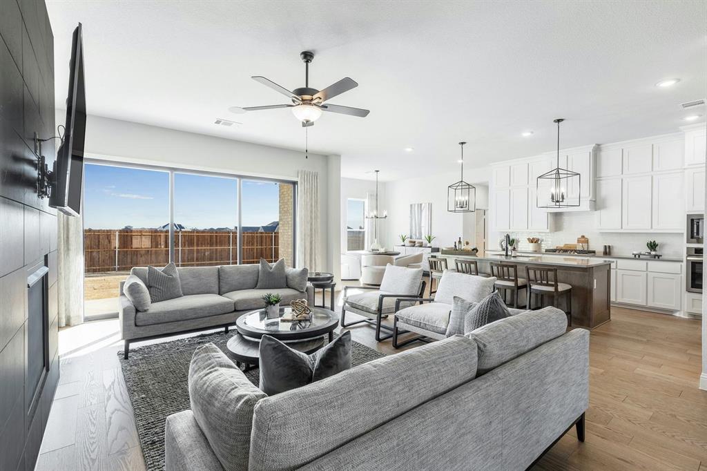 Living room and kitchen of Kentsdale Farms home in DeSoto, TX by Kindred Homes
