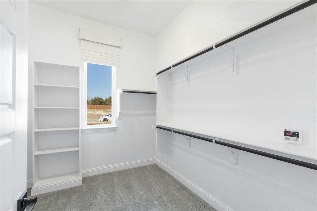 Master closet of Kentsdale Farms home in DeSoto, TX by Kindred Homes