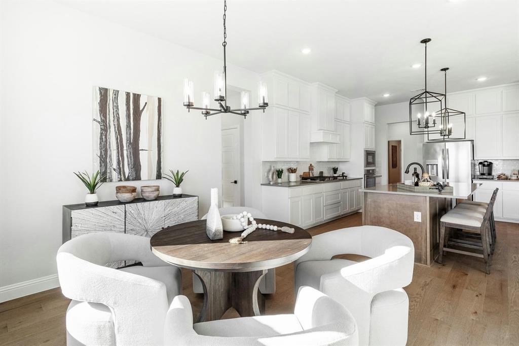 Table and kitchen of Kentsdale Farms home in DeSoto, TX by Kindred Homes