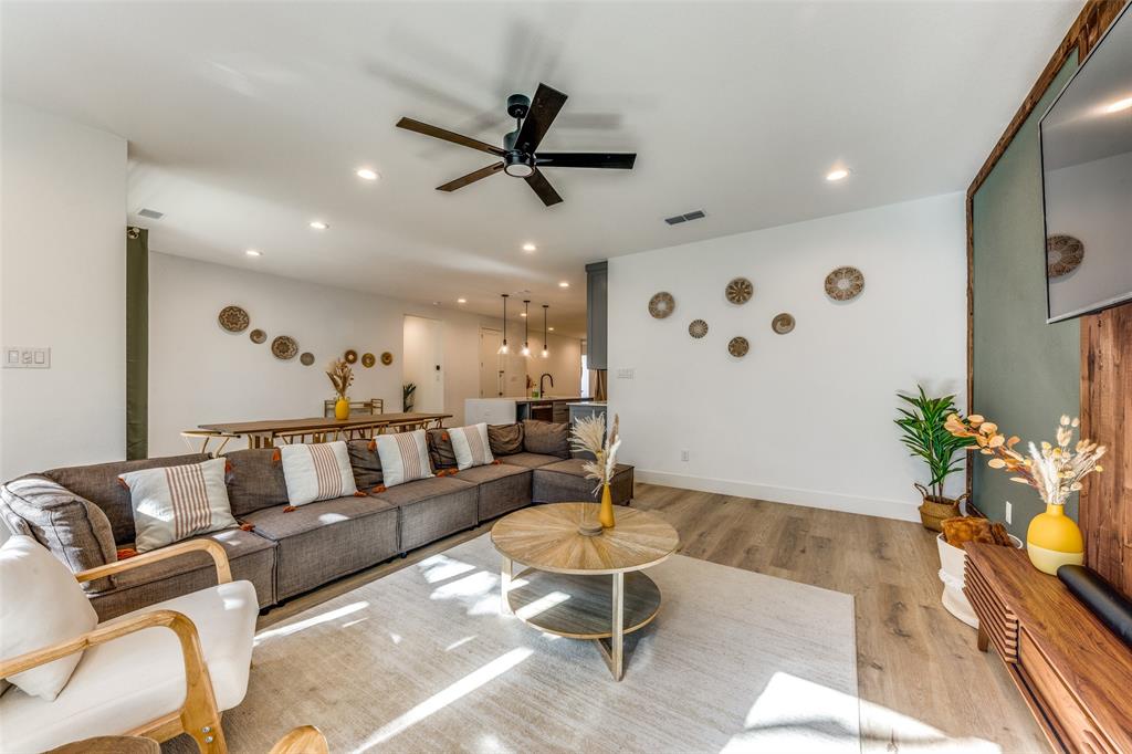 Open-concept living area featuring wood-finish flooring, recessed lighting, and a contemporary ceiling fan