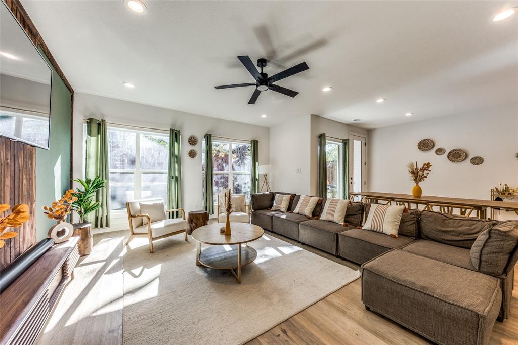Open-concept living area featuring wood-finish flooring, recessed lighting, and a contemporary ceiling fan