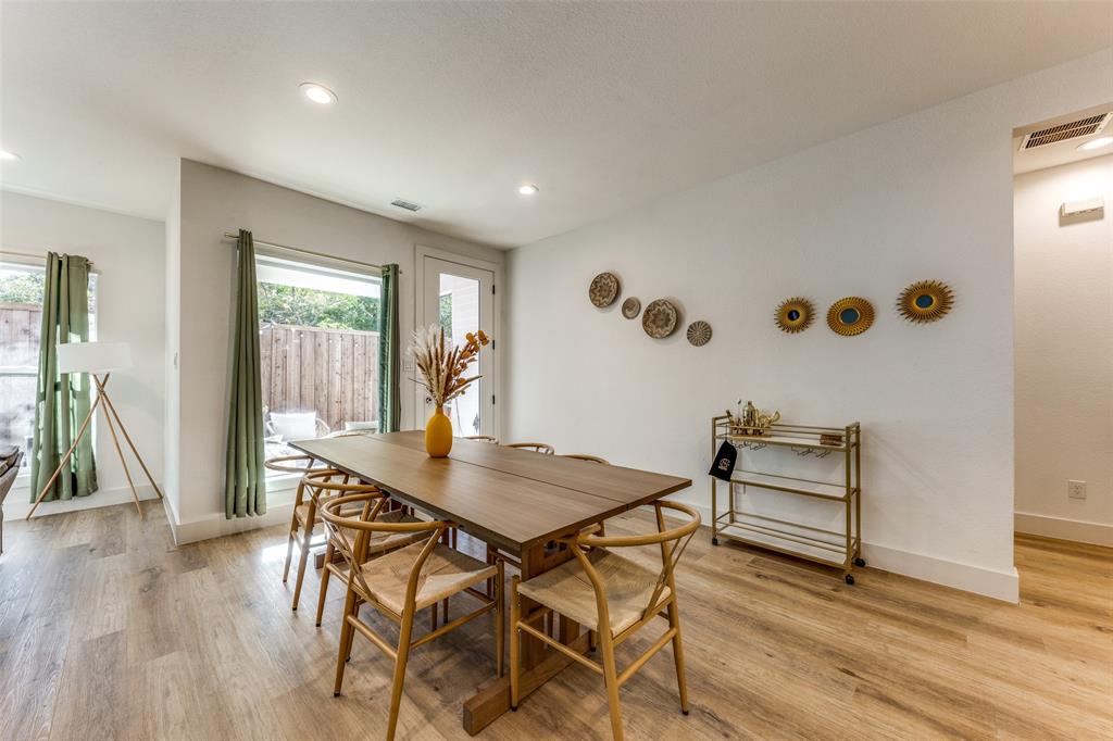 Dining area featuring light wood-finish flooring, recessed lighting, and a modern dining table