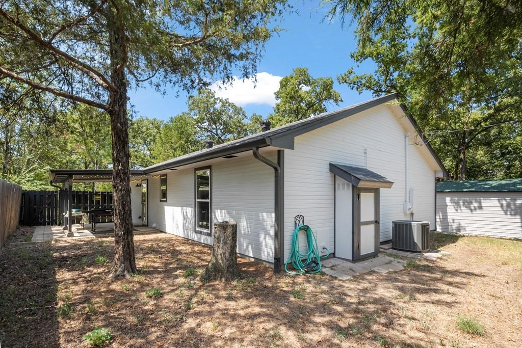Rear view of house, back porch & propane tank close